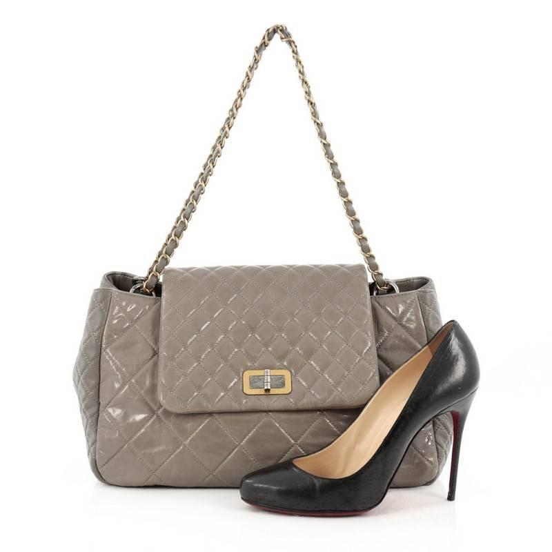 This authentic Chanel Accordion Reissue Flap Bag Quilted Calfskin Maxi borrows from its timeless reissue collection mixing modern luxury with classic styling. Crafted in grey diamond quilted calfskin leather, this oversized bag features woven in