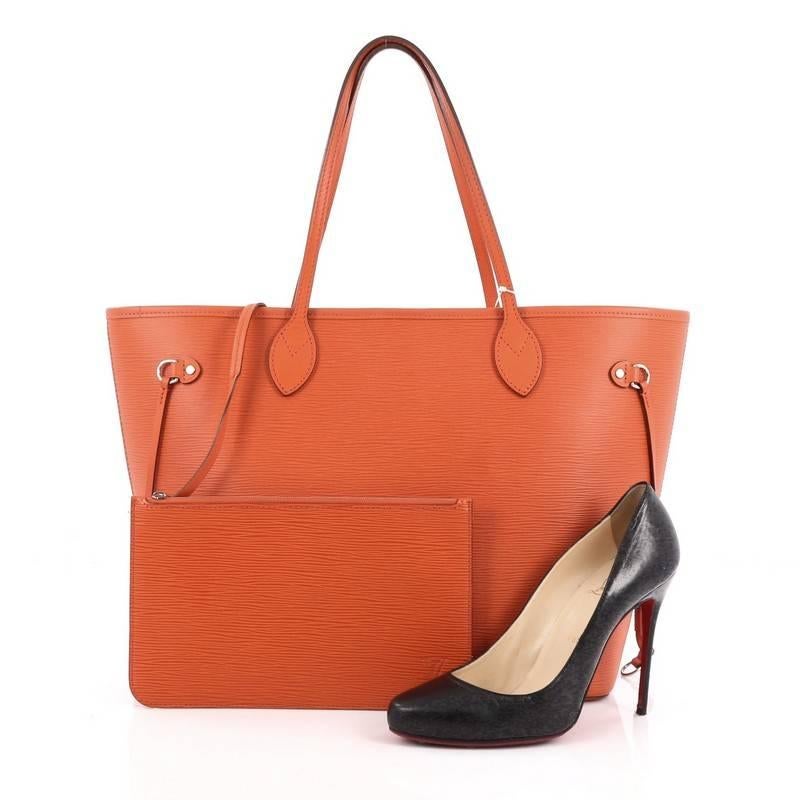 This authentic Louis Vuitton Neverfull Tote Epi Leather MM is a perfect companion for daily excursions. Crafted in piment orange epi leather, this iconic, easy-to-carry tote features dual flat leather handles, side tassels that cinches and expands
