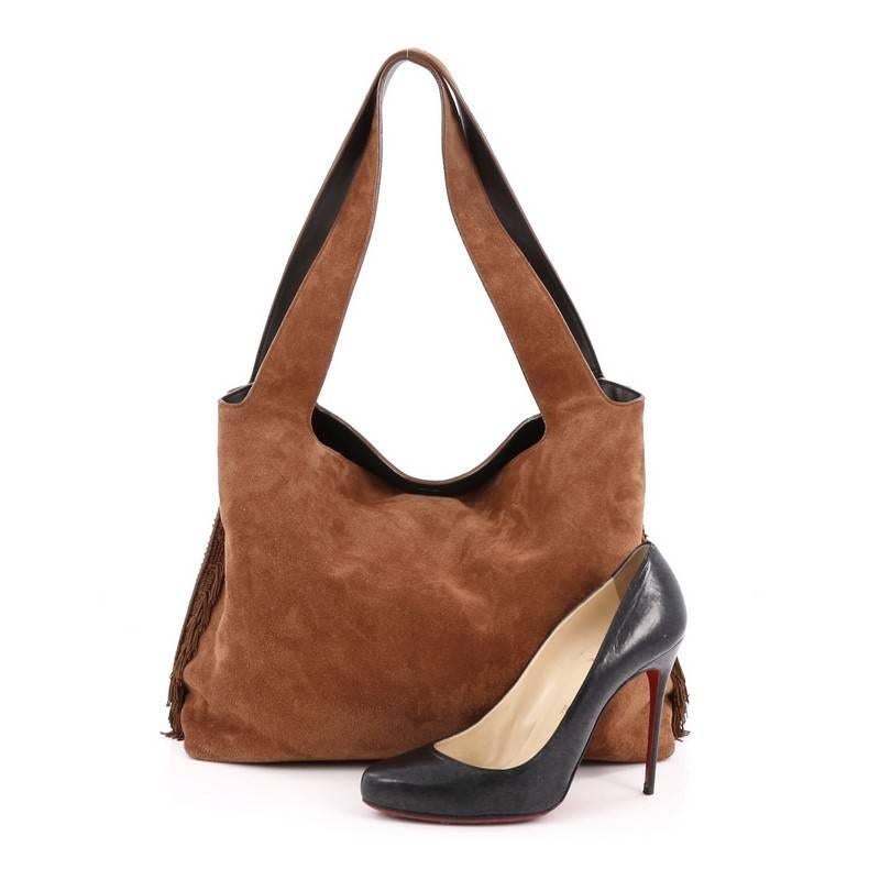 This authentic The Row Duplex Hobo Suede with Fringe mixes the brand's effortless and understated luxury with functional minimalist designs. Crafted from brown suede, this modern hobo features flat shoulder straps, slouchy silhouette, fringe side