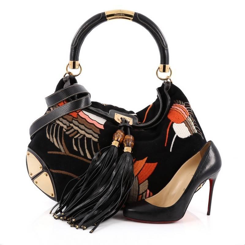 This authentic Gucci Indy Hobo Embroidered Velvet Large showcases the brand's classic design with luxurious detailing adding an industrial chic twist. Crafted from black velvet with multicolor blue bell embroidery, this eye-catching hobo features