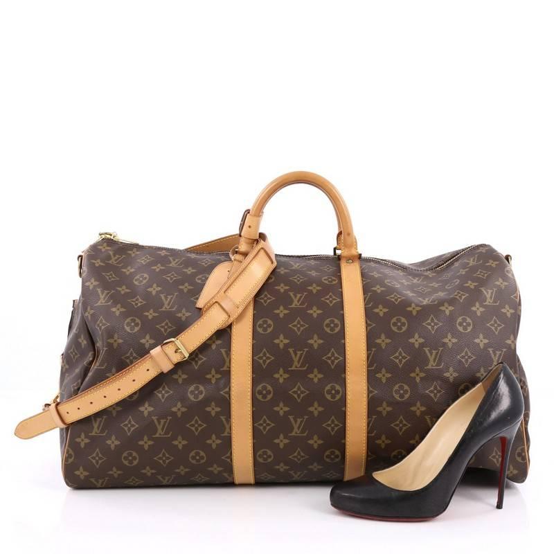 This authentic Louis Vuitton Keepall Bandouliere Bag Monogram Canvas 55 is the perfect purchase for a weekend trip, and can be effortlessly paired with any outfit from casual to formal. Crafted with traditional Louis Vuitton monogram coated canvas,