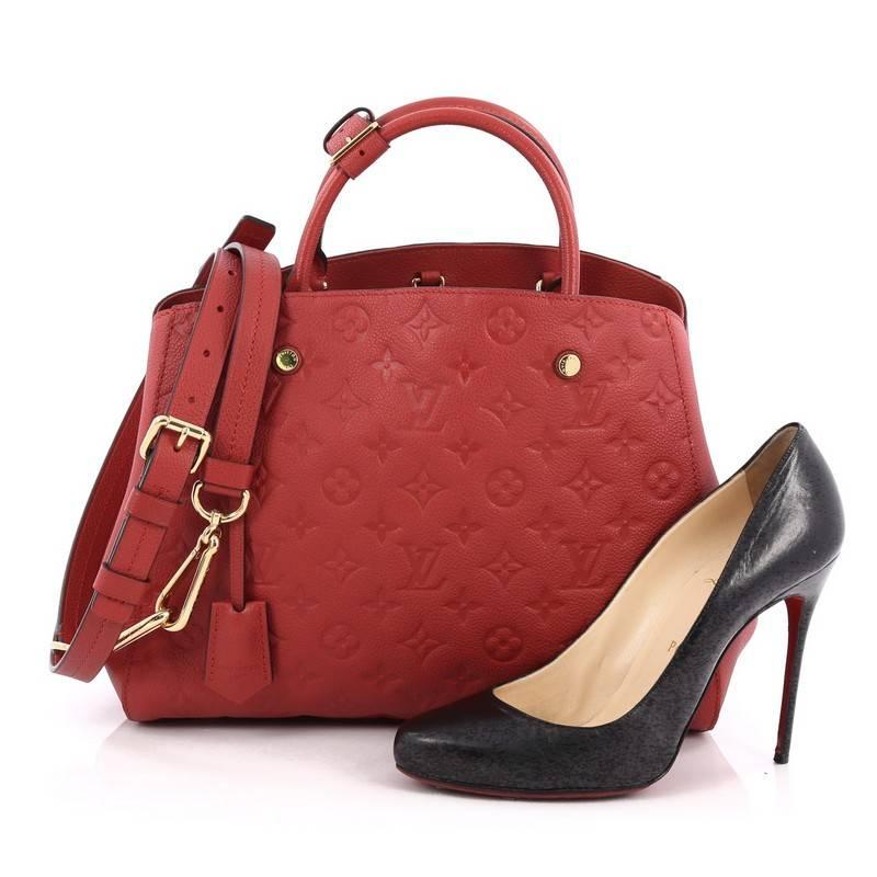 This authentic Louis Vuitton Montaigne Handbag Monogram Empreinte Leather MM named after the famed Parisian location is as sophisticated as it is sturdy. Crafted in cherry red monogram empreinte leather, this luxurious and refined bag features