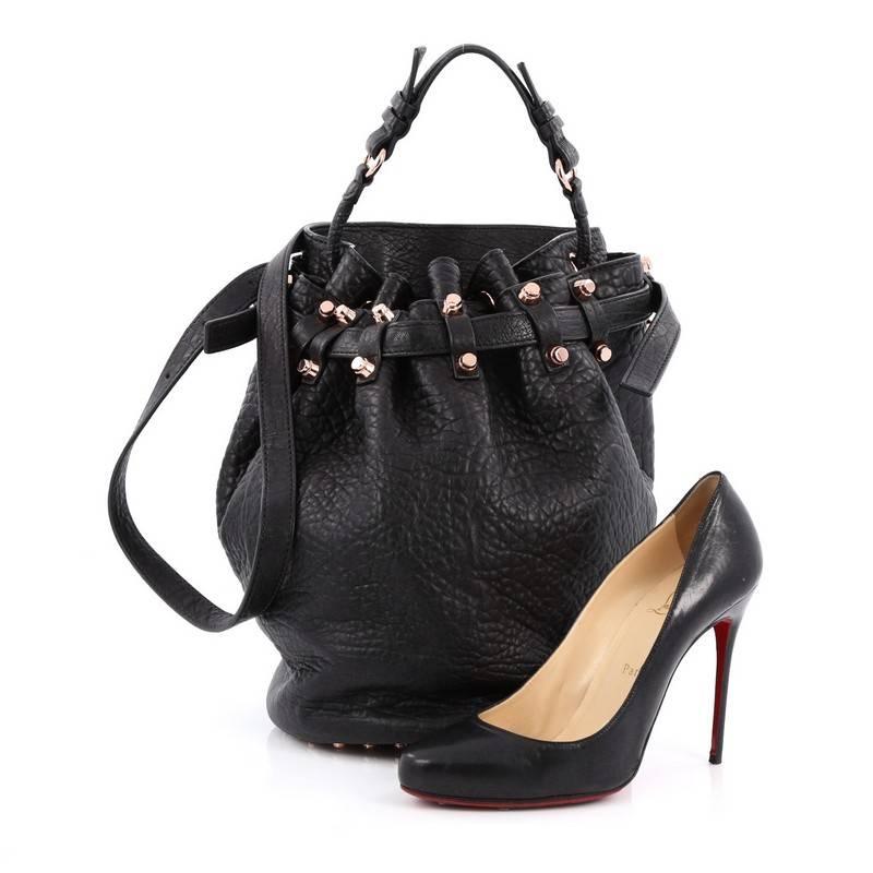 This authentic Alexander Wang Diego Bucket Bag Leather Large is a highly sought-after bag with a stylishly edgy look. Crafted from black leather, this popular bucket bag features flat leather handle, adjustable leather strap, rose gold cone-shaped