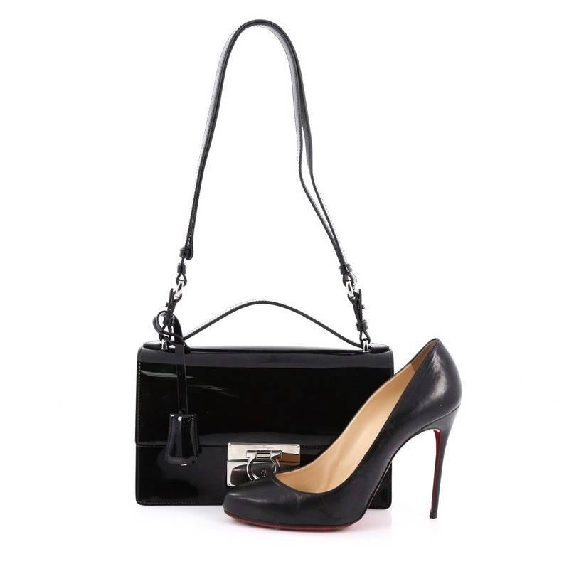 This authentic Salvatore Ferragamo Aileen Shoulder Bag Patent Medium is an impeccably chic and timeless shoulder bag ideal for modern fashionista. Crafted from black patent leather, this bag features adjustable shoulder strap, logo-embossed clasp