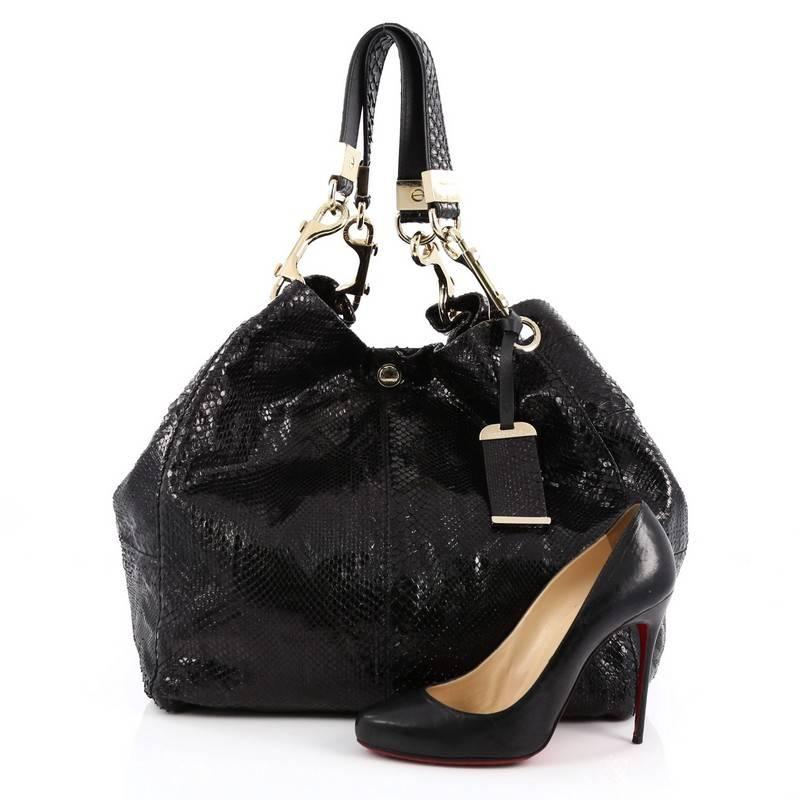 This authentic Jimmy Choo Lohla Tote Python Large is a simple fuss-free tote made for everyday. Crafted from genuine black python skin, this large tote bag features dual leather gold link and flat python straps for a casual sophisticated look,