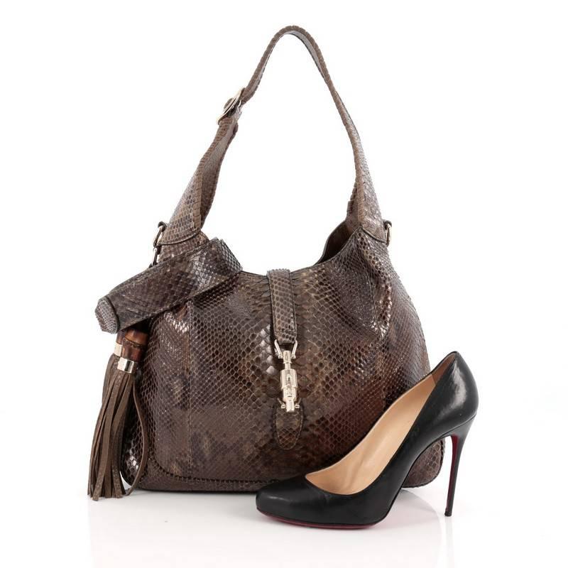 This authentic Gucci New Jackie Handbag Python Medium is a must-have luxurious everyday hobo fit for the modern woman. Constructed from genuine brown and green python skin, this bag features side fringe tassels with bamboo accents, cross leather and