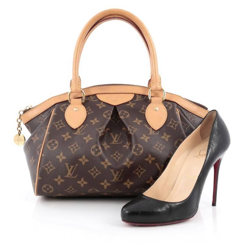 This authentic Louis Vuitton Tivoli Handbag Monogram Canvas PM inspired by the Italian city itself combines chic and feminine luxury for everyday use. Crafted from iconic brown monogram coated canvas, this bag features dual-rolled vachetta leather