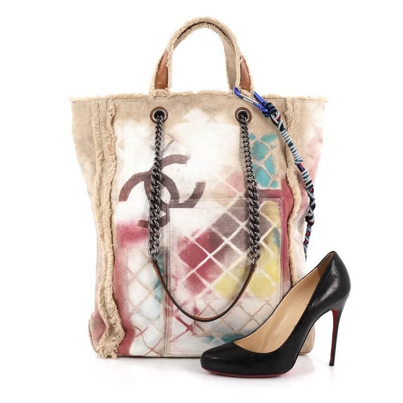 This authentic Chanel Art School Oh My Boy Tote Graffiti Canvas from the brand's Spring / Summer 2014 Bag Collection is the ultimate street-style chic perfect for the modern fashionista. Crafted from tan graffiti printed and sprayed canvas with
