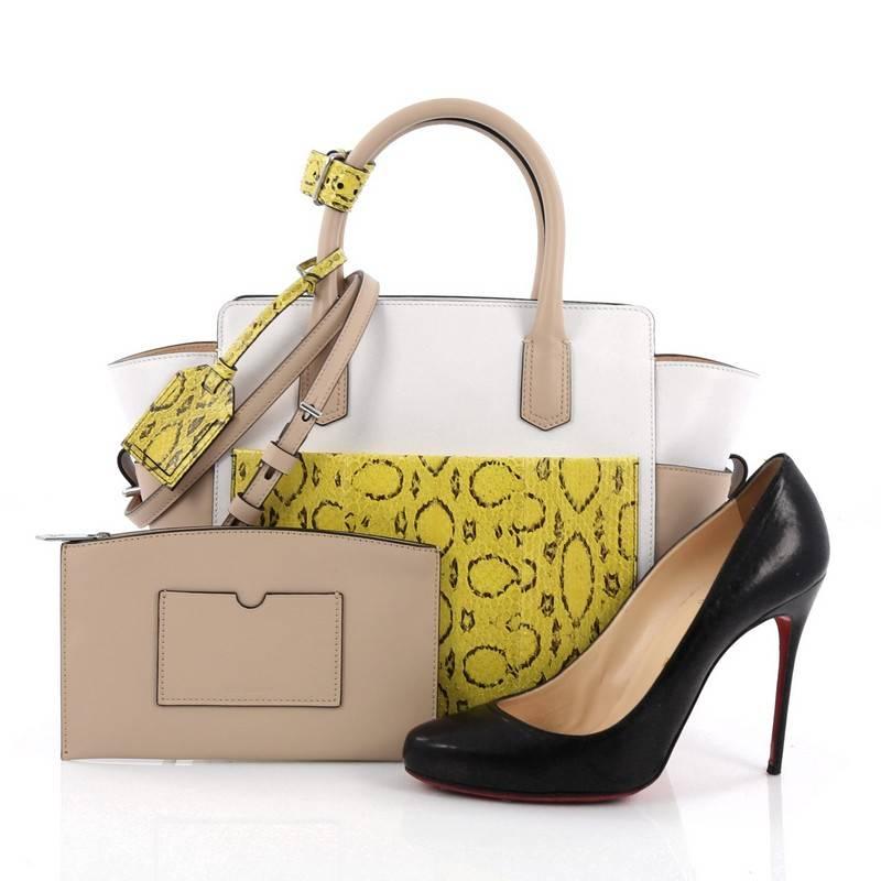 This authentic Reed Krakoff Atlantique Tote Leather and Python Mini is perfect for the modern woman. Crafted in white and beige leather, this sophisticated, petite tote features dual-rolled leather top handles, front patch and zip pocket in yellow