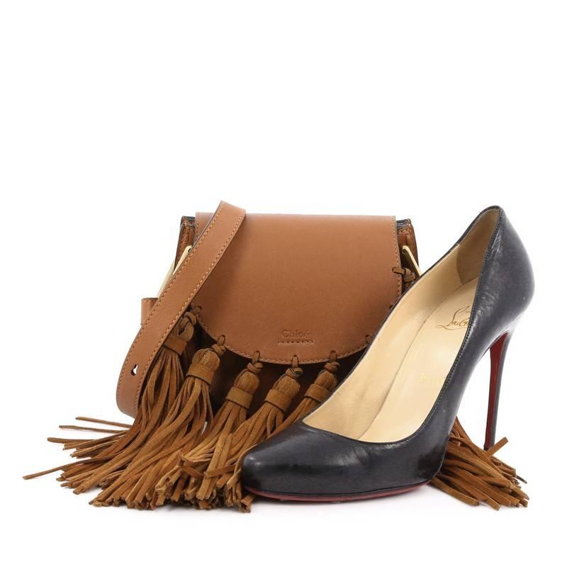 This authentic Chloe Hudson Fringe Tassel Handbag Leather Mini mixes casual-bohemian styling with luxurious edge made for the Chloe girl. Crafted from light brown leather and suede, this saddle-style, crossbody bag features an adjustable, long, flat