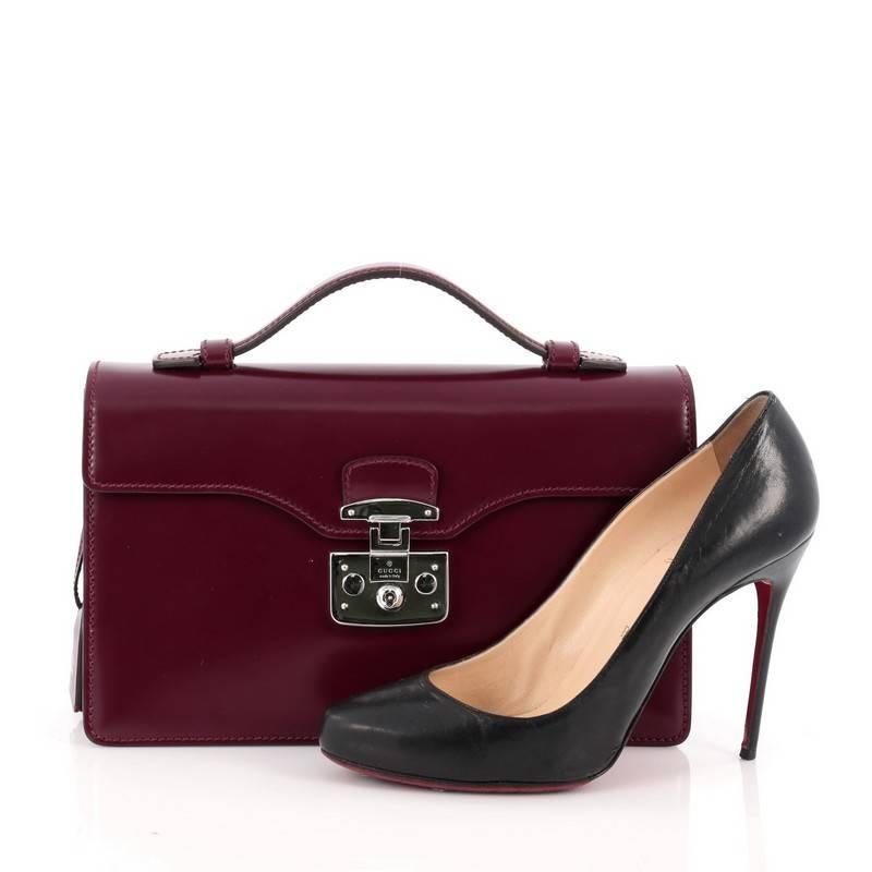 This authentic Gucci Lady Lock Briefcase Clutch Leather is your perfect accessory for work. Crafted in plum leather, this briefcase features top handle, lady lock closure, frontal flap, accordion sides, leather clochette and chrome-hardware accents.