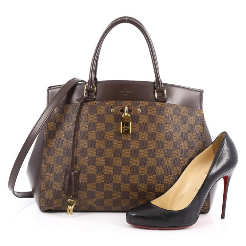 This authentic Louis Vuitton Rivoli Handbag Damier MM is designed for style-conscious professionals with luxurious taste. Crafted in popular damier ebene canvas, this functional bag features a sleek silhouette with two outer flat pockets,