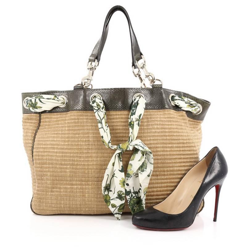This authentic Gucci Positano Tote Raffia with Snakeskin Large is a striking, fashionable tote for on-the-go moments. Crafted from brown raffia straw, this chic tote features genuine green snakeskin trims, printed floral silk scarf interlaced at the