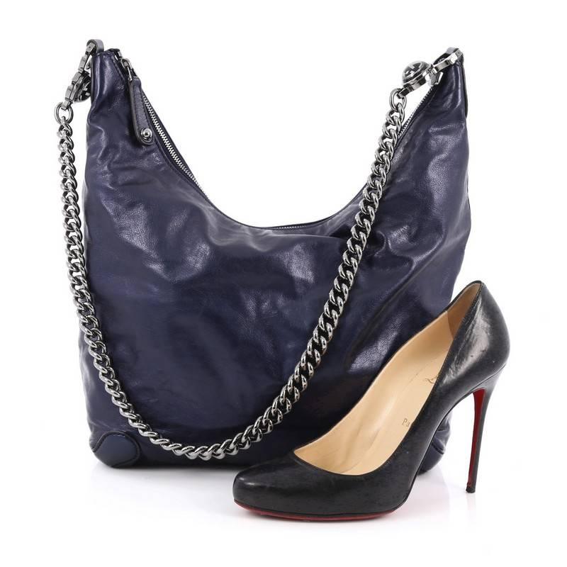 This authentic Gucci Galaxy Hobo Leather Medium is simple yet showcases a subtle edge perfect for the modern woman. Crafted in sleek and shiny blue metallic leather, this slouchy, easy-to-carry hobo features a long chunky gunmetal chain-link strap