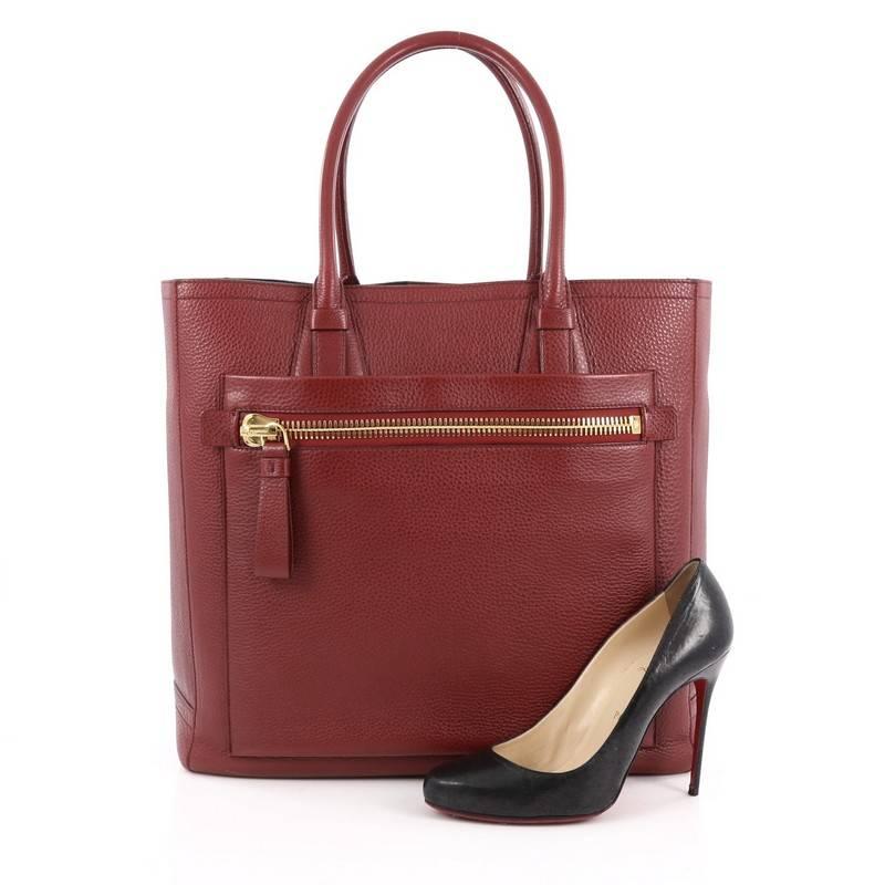 This authentic Tom Ford Summer Tote Pebbled Leather Large is a classic piece perfect for everyday use. Crafted in red pebbled leather, this tote features dual-rolled leather handles, exterior front zip pocket, protective base studs and gold-tone