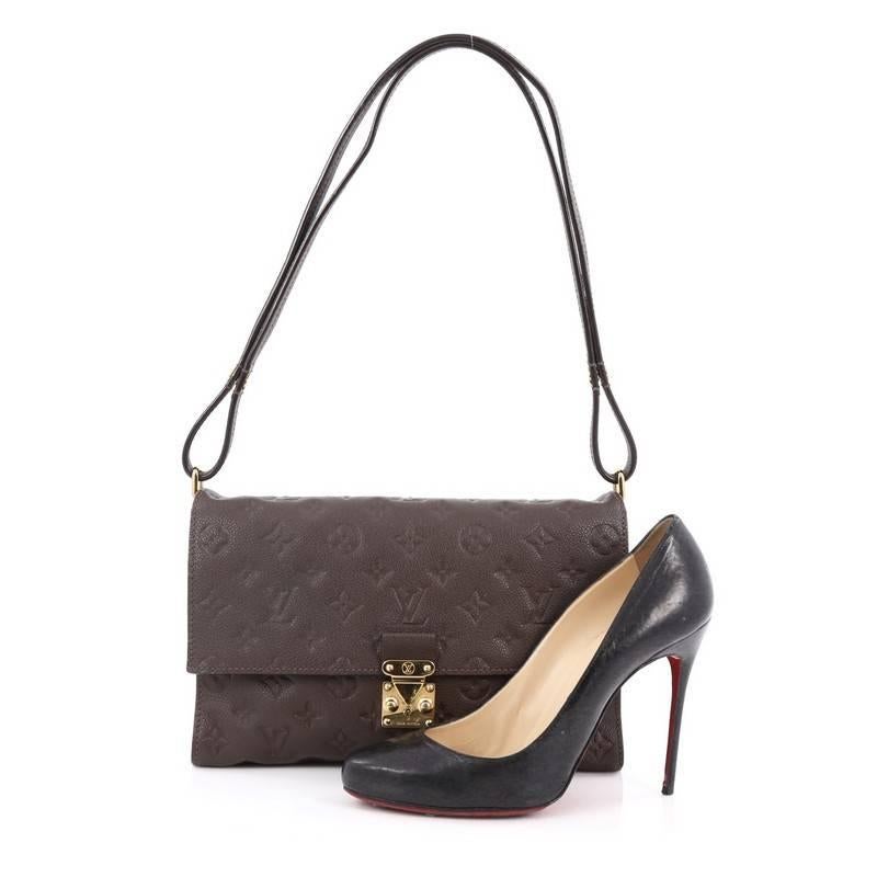 This authentic Louis Vuitton Fascinante Handbag Monogram Empreinte Leather mixes modern design with elegant versatility. Crafted from terre brown monogram empreinte leather, this versatile flap bag features an adjustable leather strap that allows it