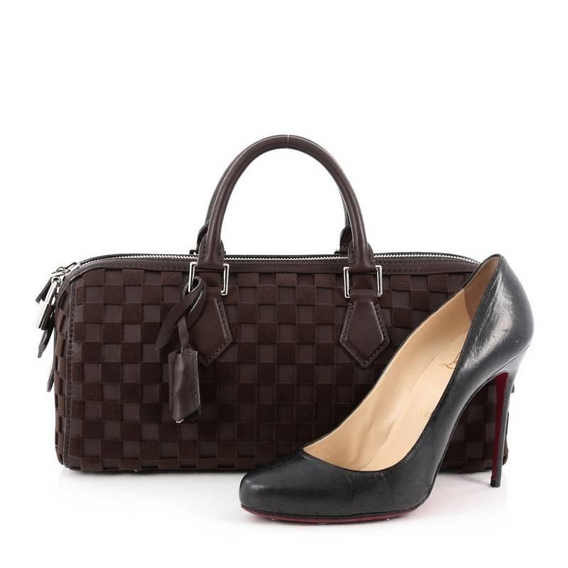This authentic Louis Vuitton Speedy Cube Bag Damier Leather and Velvet East West is from the brands' Spring-Summer 2013 Collection, created by Marc Jacobs with inspiration from graphic patterns, stripes, and grids. Crafted from brown leather and