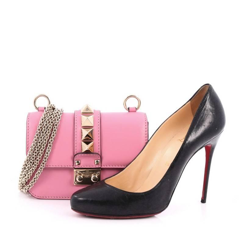 This authentic Valentino Glam Lock Shoulder Bag Leather Mini is a fun, exciting and bold accessory perfect for night outs. Crafted from pink leather, this beautiful flap bag features a long detachable gold-tone chain strap that allows it to be worn