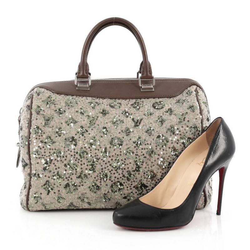 This authentic Louis Vuitton Speedy Handbag Limited Edition Sunshine Express 30 presented at the brand's Fall/Winter 2012 Collection is a glittery twist on the classic speedy design. Crafted from gray wool and embellished green embroidered luminous