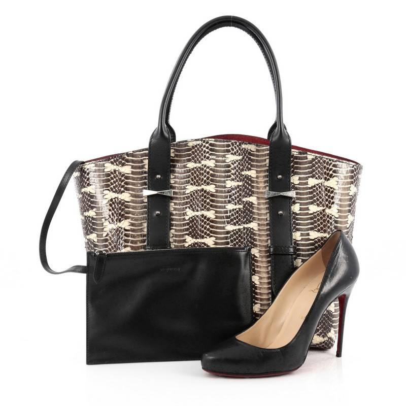 This authentic Alexander McQueen Legend Tote Python Small is a unique and elegant piece perfect for fashion-forward women. Crafted in genuine brown python skin, this tote features dual-rolled black leather handles with belted leather details,