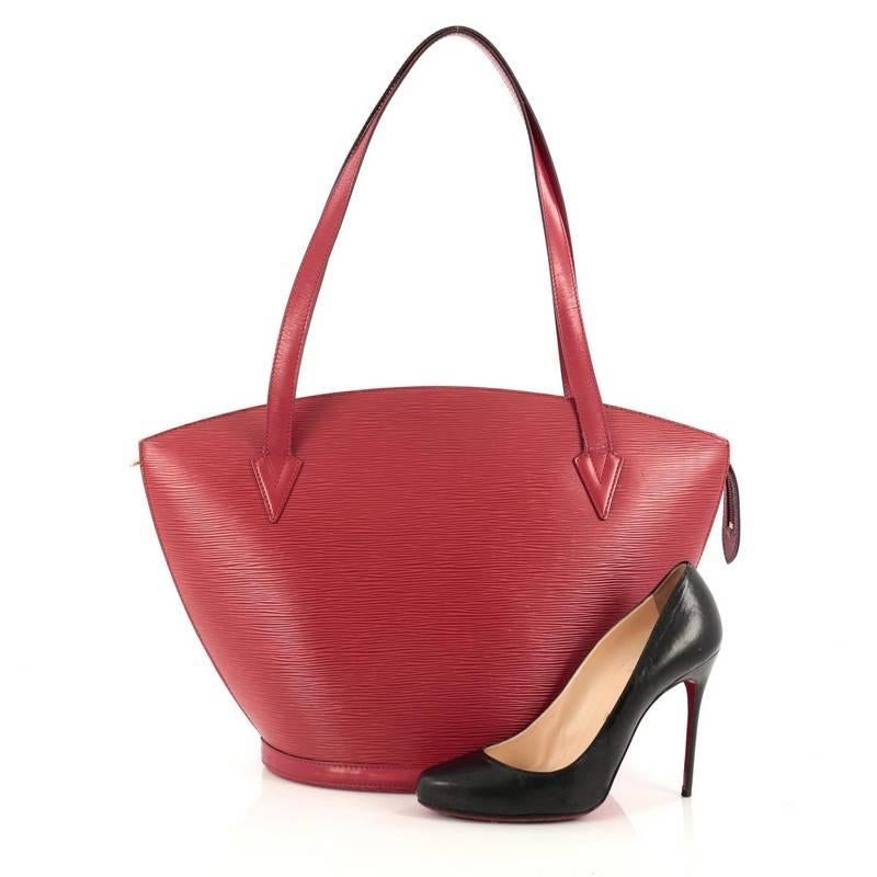 This authentic Louis Vuitton Saint Jacques Handbag Epi Leather GM is refined and elegant. Crafted from Louis Vuitton's signature red epi leather and sturdy base, this fan-shaped bag features dual flat leather shoulder straps, subtle LV logo at the