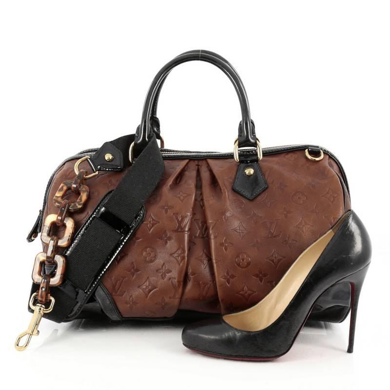 This authentic Louis Vuitton Stephen Handbag Monogram Embossed Leather is a unique, coveted piece created by iconic artist, Stephen Sprouse made for any LV lover. Crafted from brown monogram embossed leather, this duffle bag features dual-rolled