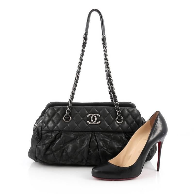 This authentic Chanel Chic Bowling Bag Quilted Calfskin showcases timeless design with luxurious, modern edge. Crafted from black calfskin leather, this chic bowling bag features woven-in leather chain straps with leather pads, diamond quilted