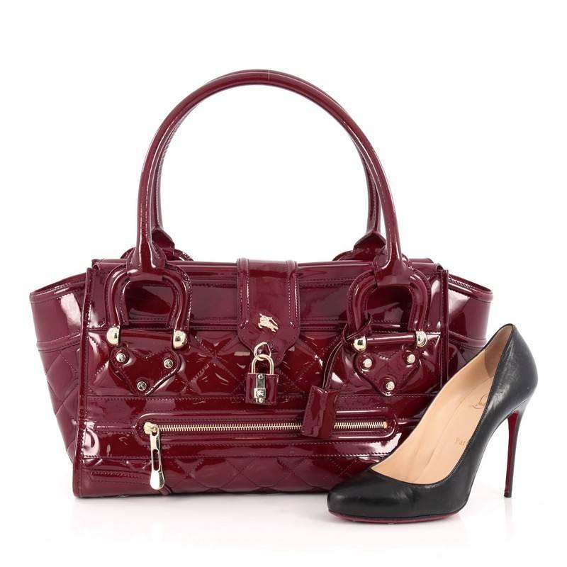 This authentic Burberry Manor Bag Quilted Patent Large is sophisticated in style perfect for everyday casual look. Crafted from red patent quilted leather, this bag features dual-rolled leather handles, exterior front zip pocket, expandable sides,