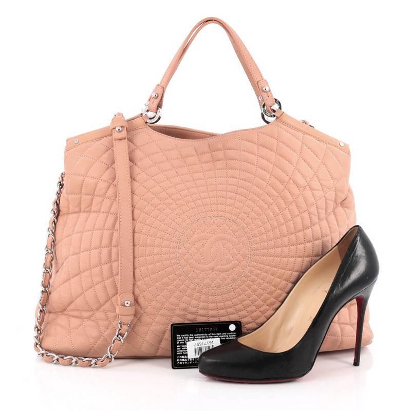 This authentic Chanel Spiral Sea Hit Tote Quilted Iridescent Calfskin Large is a stylish large tote and an ideal everyday bag with room for all of your necessities. Crafted from light pink fine spiral radiating quilted iridescent calfskin leather,