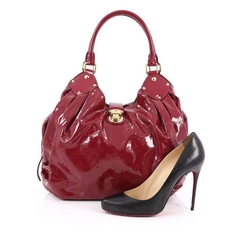 This authentic Louis Vuitton L Hobo Surya Leather is sleek and refined in design apt for the modern woman. Crafted in cerise red monogram surya leather, this oversized sun-inspired hobo features dual-rolled handles, buckle and stud details,