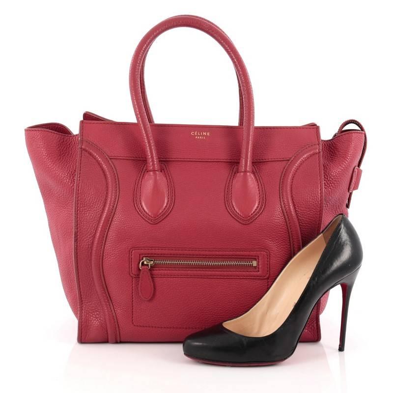 This authentic Celine Luggage Handbag Grainy Leather Mini epitomizes Phoebe Philo's minimalist yet chic style. Constructed in red grainy leather, this beloved fashionista's bag features dual-rolled leather handles, a frontal zip pocket, Celine's