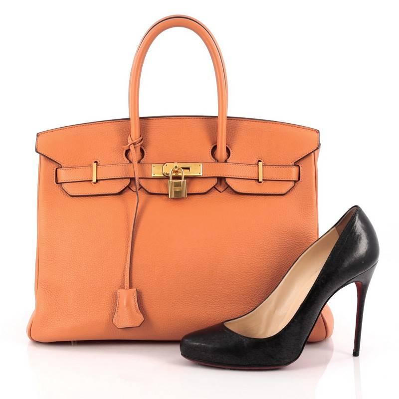 This authentic Hermes Birkin Handbag Orange Clemence with Gold Hardware 35 stands as one of the most-coveted bags fit for any fashionista. Constructed from sturdy, scratch-resistant orange clemence leather, this stand-out oversized tote features