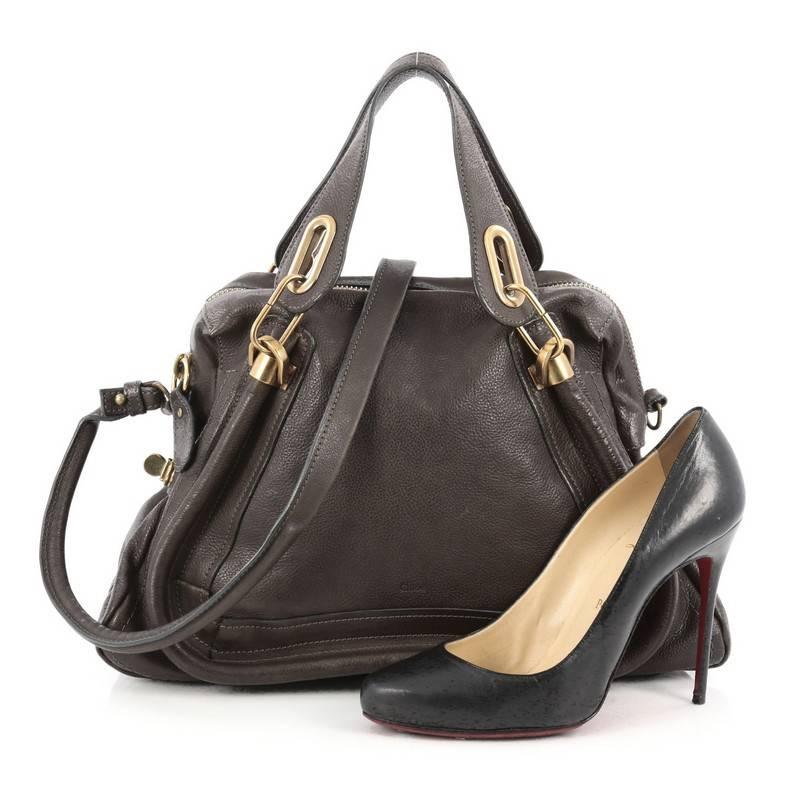 This authentic Chloe Paraty Top Handle Bag Leather Medium mixes everyday style and functionality perfect for the modern woman. Crafted from brown leather, this versatile bag features dual flat handles, piped trim details, side twist locks, and