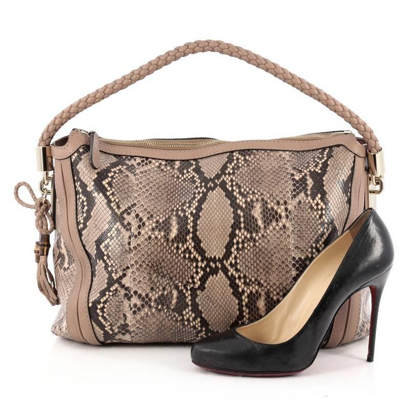 This authentic Gucci Bella Hobo Python Medium is your perfect everyday bag. Crafted in nude genuine python skin, this hobo features nude leather trim, single loop braided handle, side tassels with bamboo accents, protective base studs and gold-tone