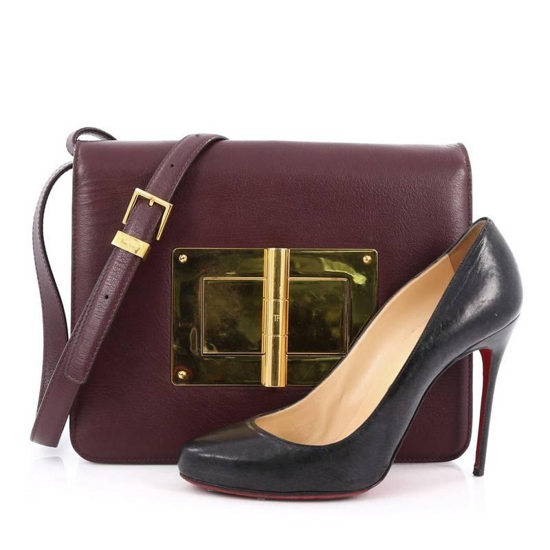 This authentic Tom Ford Natalia Convertible Clutch Leather Large redefines modern luxury with timeless elegance. Crafted from burgundy leather, this chic clutch features flat leather shoulder strap, exterior back slip pocket, and gold-tone hardware