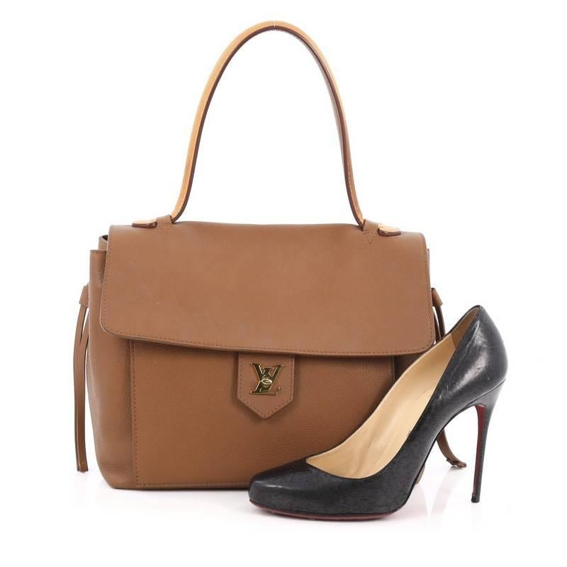 This authentic Louis Vuitton Lockme Handbag Leather PM released in the brand's 2015 Cruise Collection is a must-have signature satchel made for the modern woman. Crafted in brown leather, this sophisticated yet feminine bag features a long vachetta