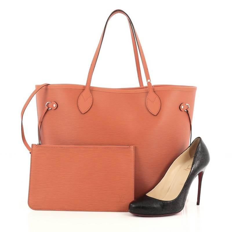 This authentic Louis Vuitton Neverfull Tote Epi Leather MM is a perfect companion for daily excursions. Crafted in orange epi leather, this iconic, easy-to-carry tote features dual flat leather handles, side tassels that cinches and expands and