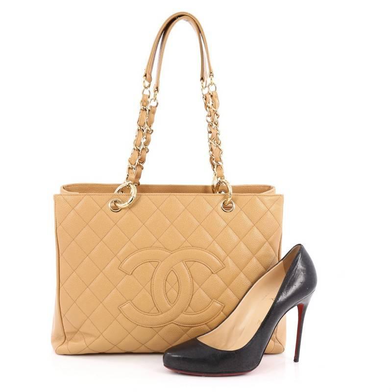 This authentic Chanel Grand Shopping Tote Quilted Caviar is perfect for everyday use with a classic yet luxurious style. Crafted in tan diamond quilted caviar leather, this versatile, timeless tote features woven-in leather chain straps with leather