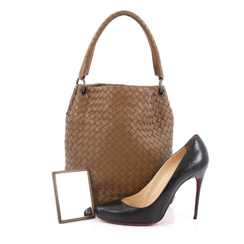 This authentic Bottega Veneta Bucket Hobo Intrecciato Nappa Small from the brand's 2010 Collection is a timelessly elegant bag made for everyday looks. Crafted in brown nappa leather woven in Bottega Veneta's signature intrecciato method, this
