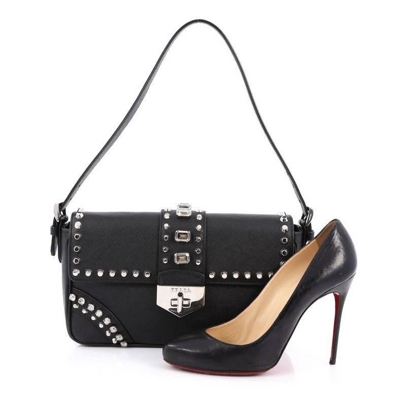 This authentic Prada Turnlock Flap Shoulder Bag Studded Saffiano Leather Medium is the perfect bag to pair for your day or night looks. Crafted from black saffiano leather, this bag features a short adjustable leather handle, diamond and studs