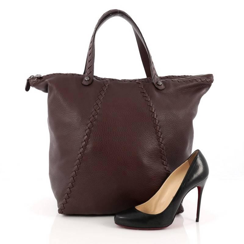 This authentic Bottega Veneta Ottone Tote Cervo Leather with Intrecciato Detail Large is an excellent day hobo with the right accent of stylishly sophisticated craftsmanship. Crafted from brown cervo leather, this bag features dual flat handles with