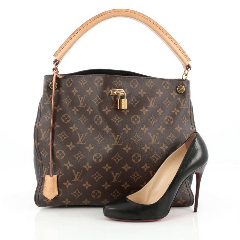 This authentic Louis Vuitton Gaia Handbag Monogram Canvas named after the Greek goddess, mixes elegant style with a feminine flair. Crafted from brown monogram coated canvas with black leather side gussets, this sophisticated bag features natural