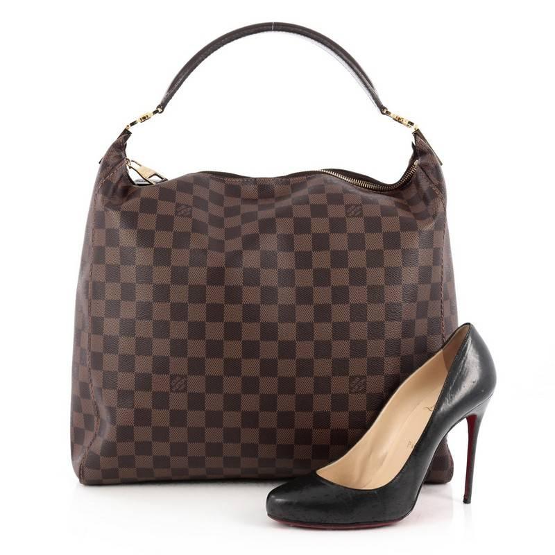 This authentic Louis Vuitton Portobello Handbag Damier GM is a modern and easy-to-carry city hobo made for everyday excursions. Crafted in signature damier ebene coated canvas, this oversized beauty features a simple silhouette, single looped