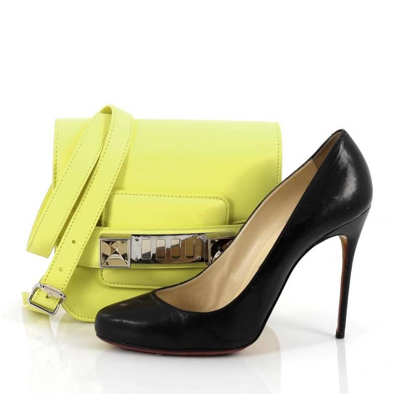 This authentic Proenza Schouler PS11 Crossbody Bag Leather Tiny is a staple among fashionistas. Constructed in neon yellow leather, this petite bag features detachable and adjustable shoulder strap, faceted cubes, fastening grill closure and silver