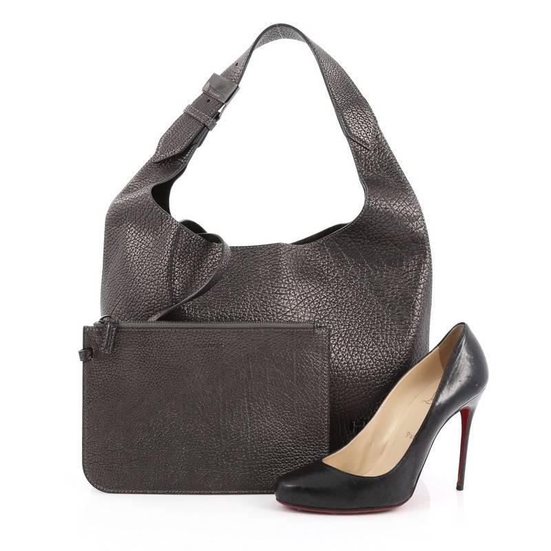 This authentic Givenchy HDG Hobo Leather Small is a refined and elegant bag and is one of the brands most prestigious collections. Crafted from grey metallic leather, this hobo features looping flat leather handle, small HDG monogrammed logo, screw