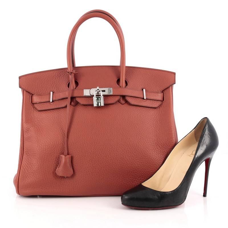 This authentic Hermes Birkin Handbag Sienne Togo with Palladium Hardware 35 stands as one of the most-coveted bags. Constructed from scratch-resistant, iconic Sienne redish brown togo leather, this stand-out tote features dual-rolled top handles,