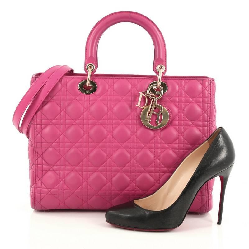 This authentic Christian Dior Lady Dior Handbag Cannage Quilt Lambskin Large is a classic staple that every fashionista needs in her wardrobe. Crafted from pink lambskin leather in Dior's iconic cannage quilting, this boxy bag features dual-rolled