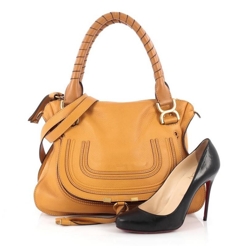 This authentic Chloe Marcie Satchel Leather Medium is perfect for the on-the-go fashionista. Constructed from mustard yellow leather, this popular satchel features wrapped leather handles, horseshoe stitched front flap, shoulder strap accented with