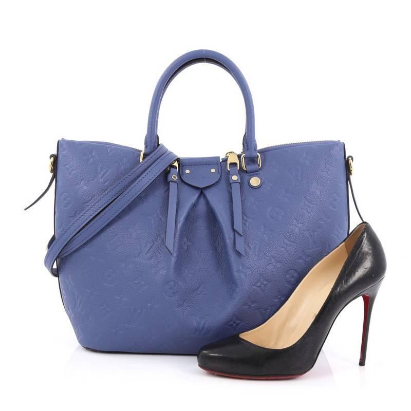 This authentic Louis Vuitton Mazarine Handbag Monogram Empreinte Leather MM is from the brand's 2016 Cruise Collection that is both stylish and feminine. Crafted from periwinkle blue monogram empreinte leather, this gorgeous bag features dual-rolled