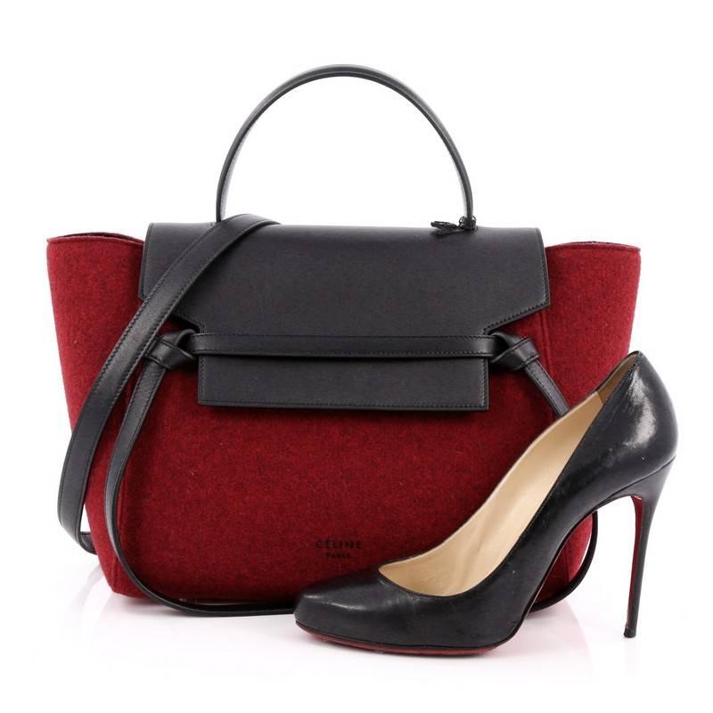 This authentic Celine Belt Bag Tweed Mini is sure to make a statement. Crafted from red felt and black leather, this bold and beautiful bag features a looped top handle, expanded wings, black leather top flap slide closure, knotted ties, exterior
